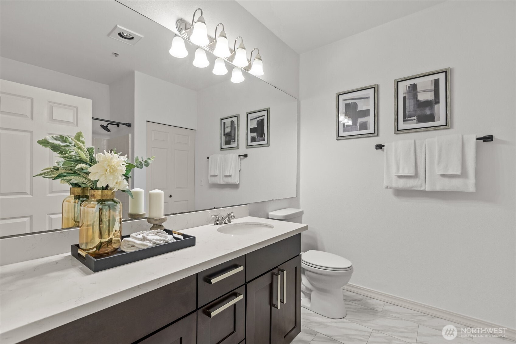 440 Maple Avenue Southwest, Unit A106 Renton, WA 98057 - Photo 22 of 39 a bathroom with a granite countertop sink a toilet and a mirror