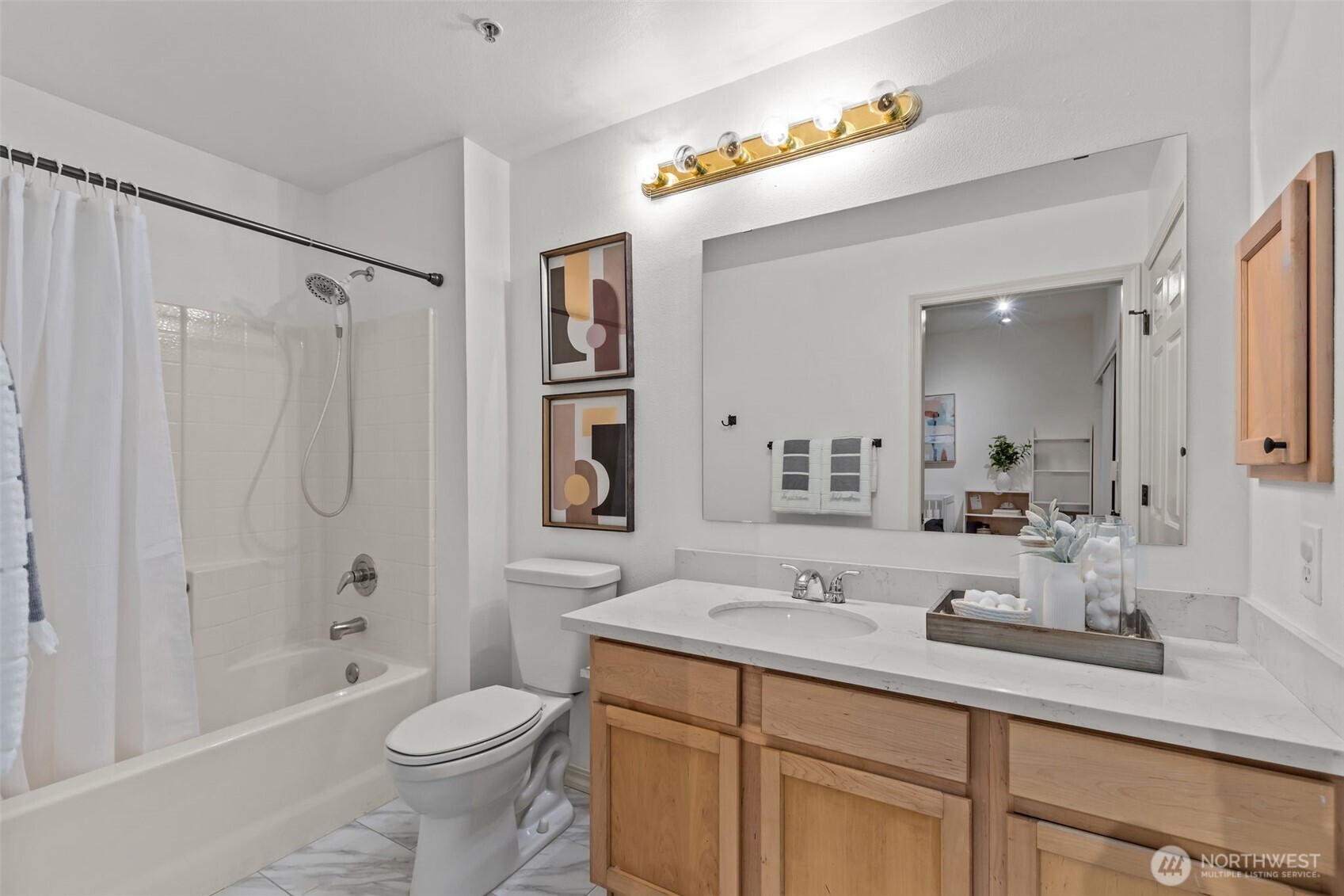 440 Maple Avenue Southwest, Unit A106 Renton, WA 98057 - Photo 28 of 39 a bathroom with a sink a toilet a mirror a bathtub and shower