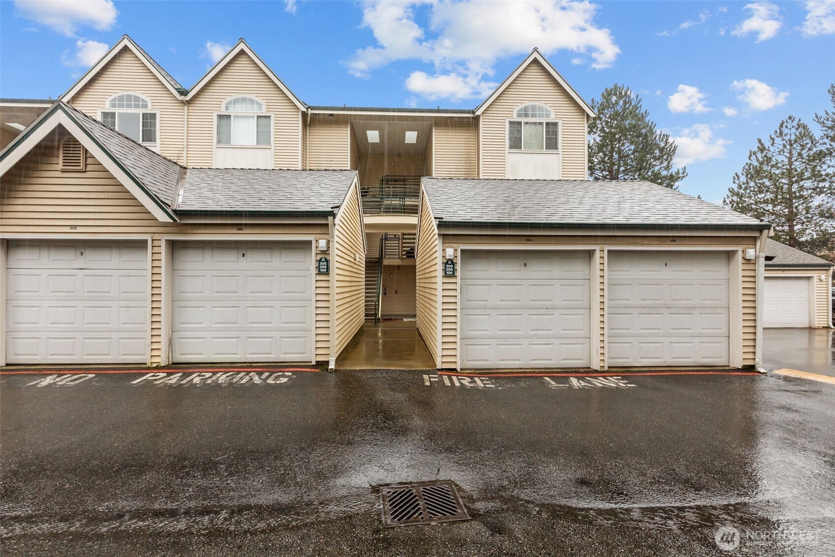 440 Maple Avenue Southwest, Unit A106 Renton, WA 98057 - Photo 37 of 39 a front view of a house with a yard and garage