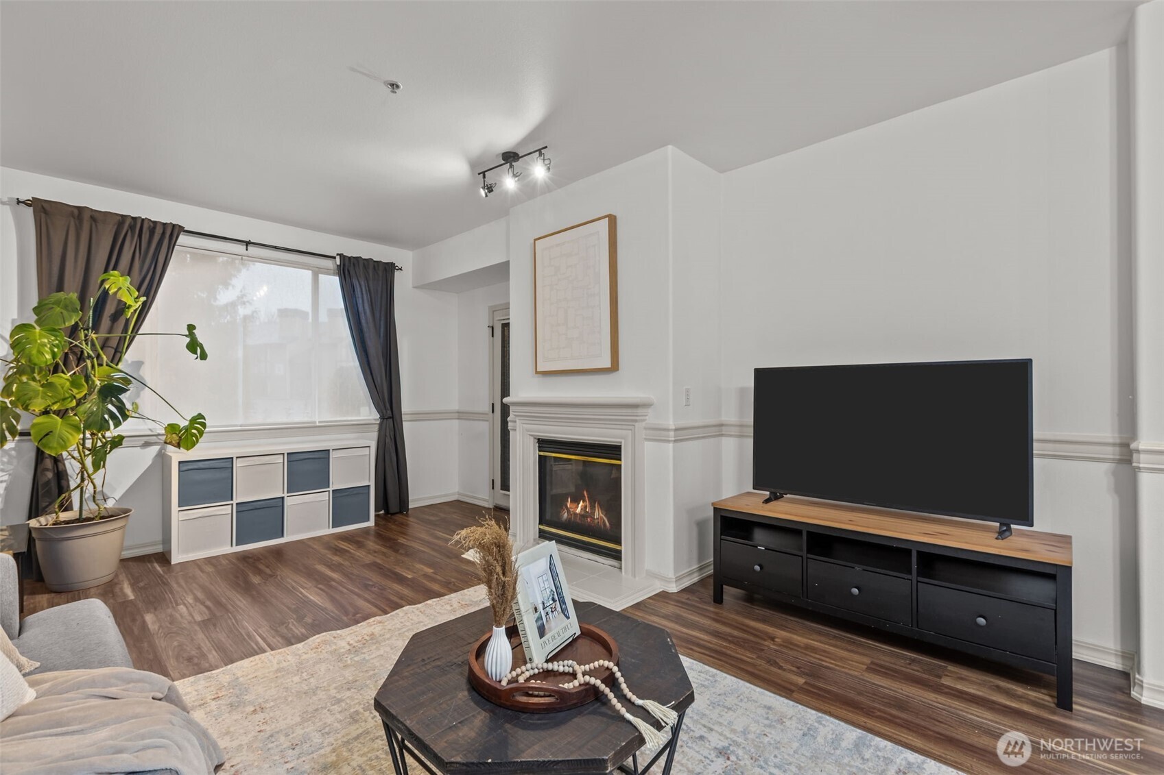 440 Maple Avenue Southwest, Unit A106 Renton, WA 98057 - Photo 5 of 39 a living room with furniture a fireplace and a flat screen tv