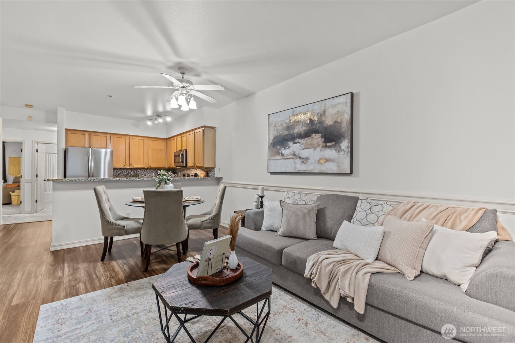 440 Maple Avenue Southwest, Unit A106 Renton, WA 98057 - Photo 8 of 39 a living room with furniture kitchen view and a chandelier