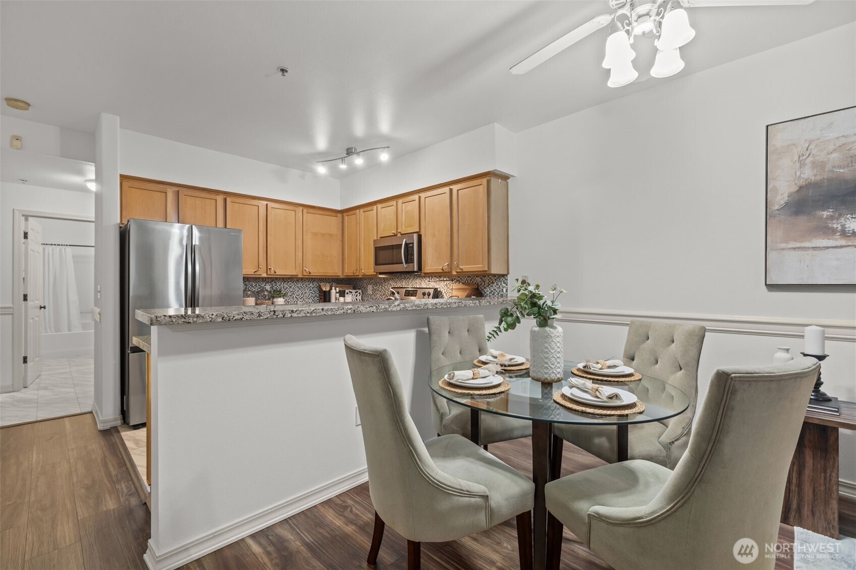 440 Maple Avenue Southwest, Unit A106 Renton, WA 98057 - Photo 10 of 39 a kitchen with stainless steel appliances a dining table chairs and chandelier