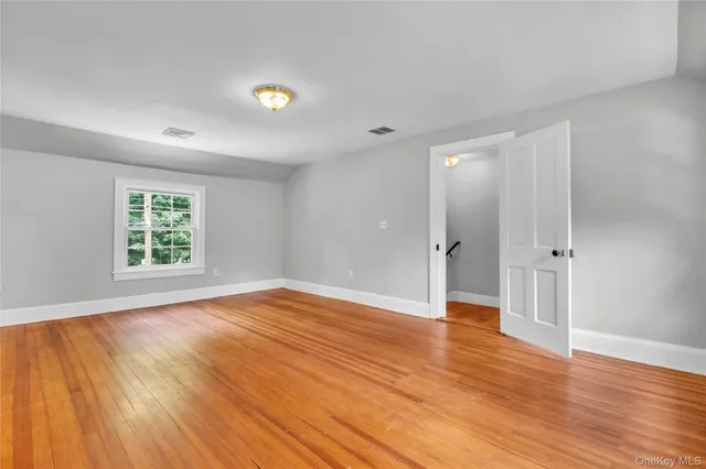 a spacious bedroom with a bed and a couch
