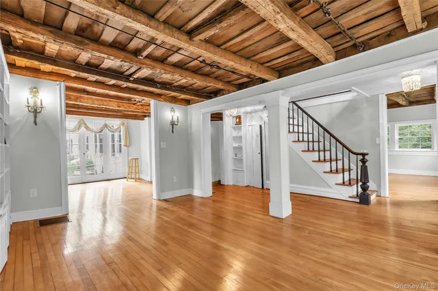 a view of an empty room with wooden floor