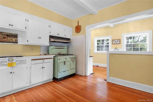 a kitchen with wooden floors and sink