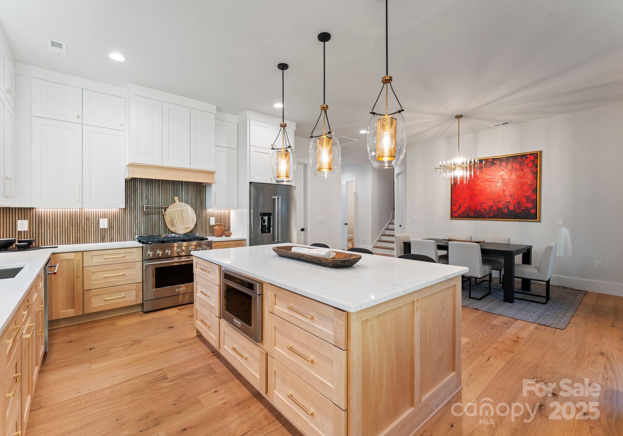 4641 Connecting Road Charlotte, NC 28209 - Photo 19 of 48 a kitchen that has a stove a sink a microwave oven a counter top space and cabinets