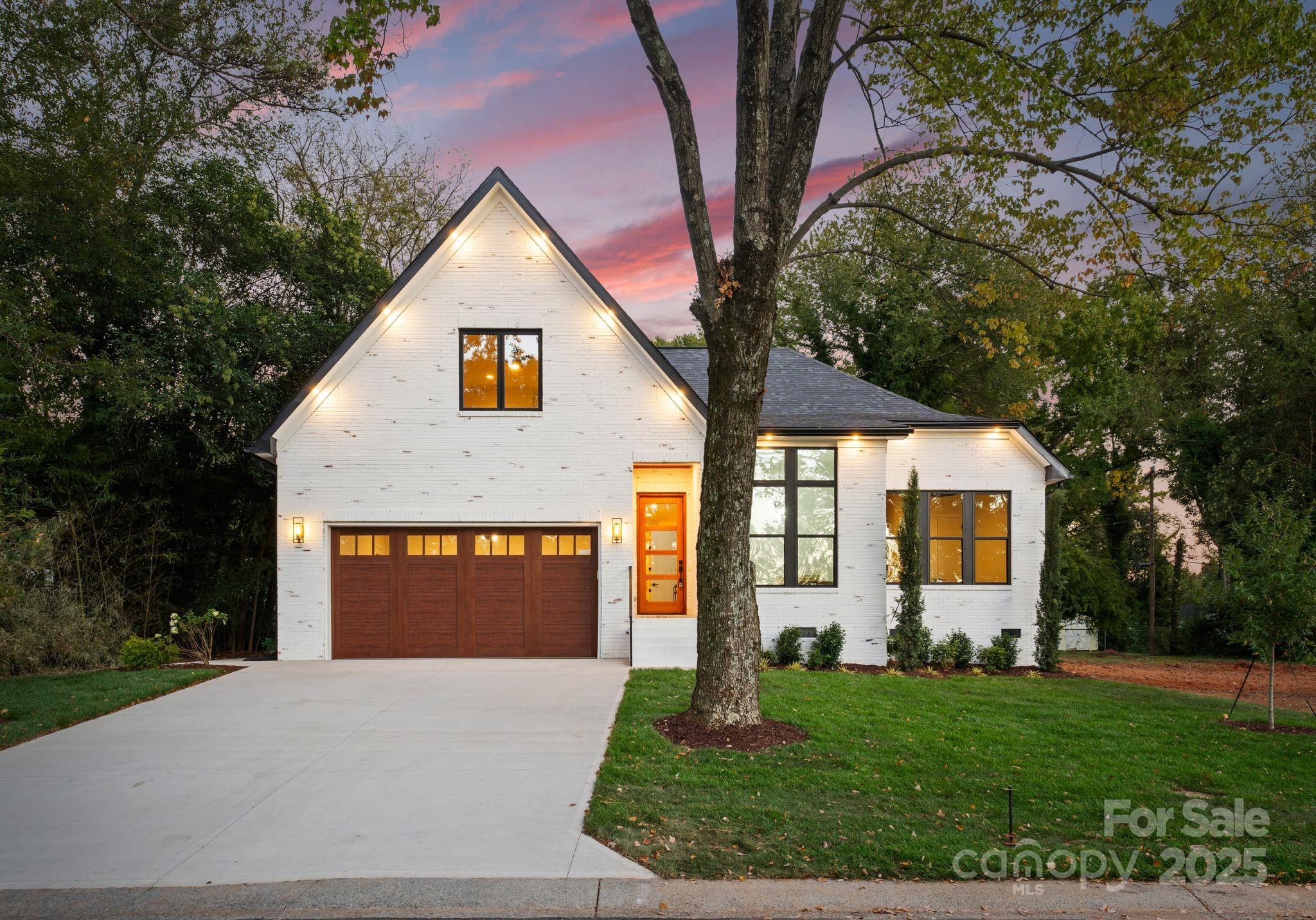 4641 Connecting Road Charlotte, NC 28209 - Photo 2 of 48 a front view of a house with a yard and garage