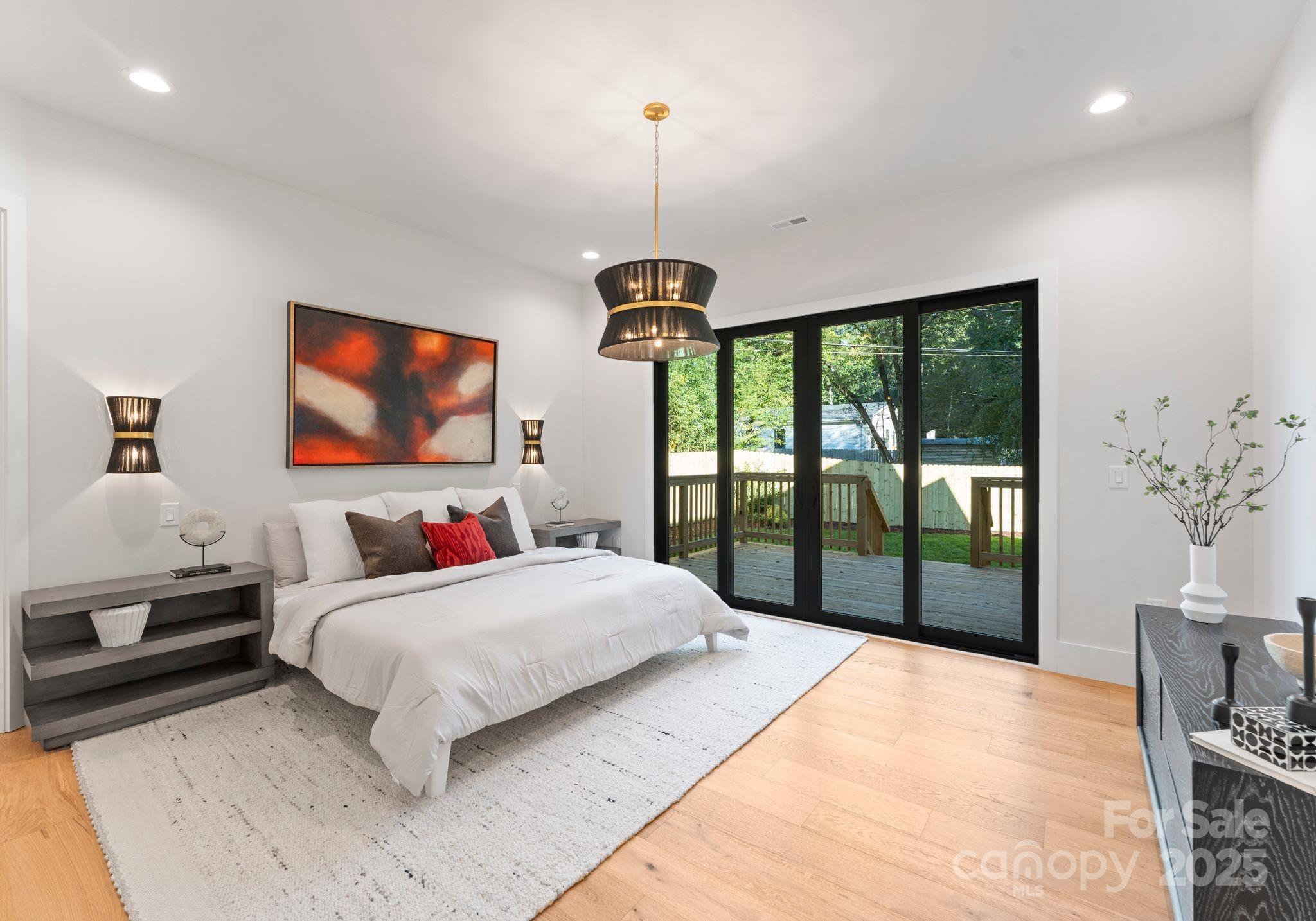 4641 Connecting Road Charlotte, NC 28209 - Photo 23 of 48 a bedroom with a bed and a flat screen tv
