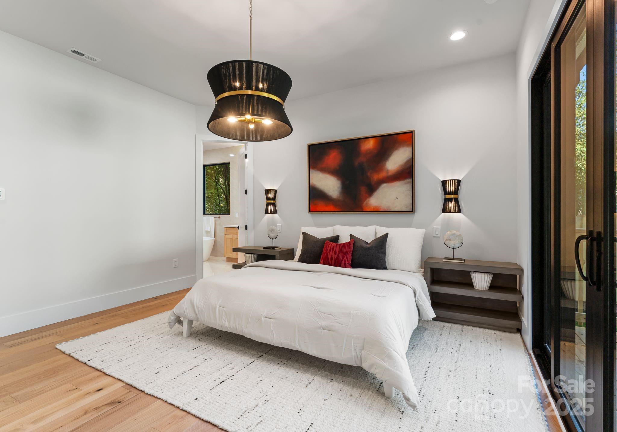 4641 Connecting Road Charlotte, NC 28209 - Photo 24 of 48 a bedroom with a bed and a flat screen tv