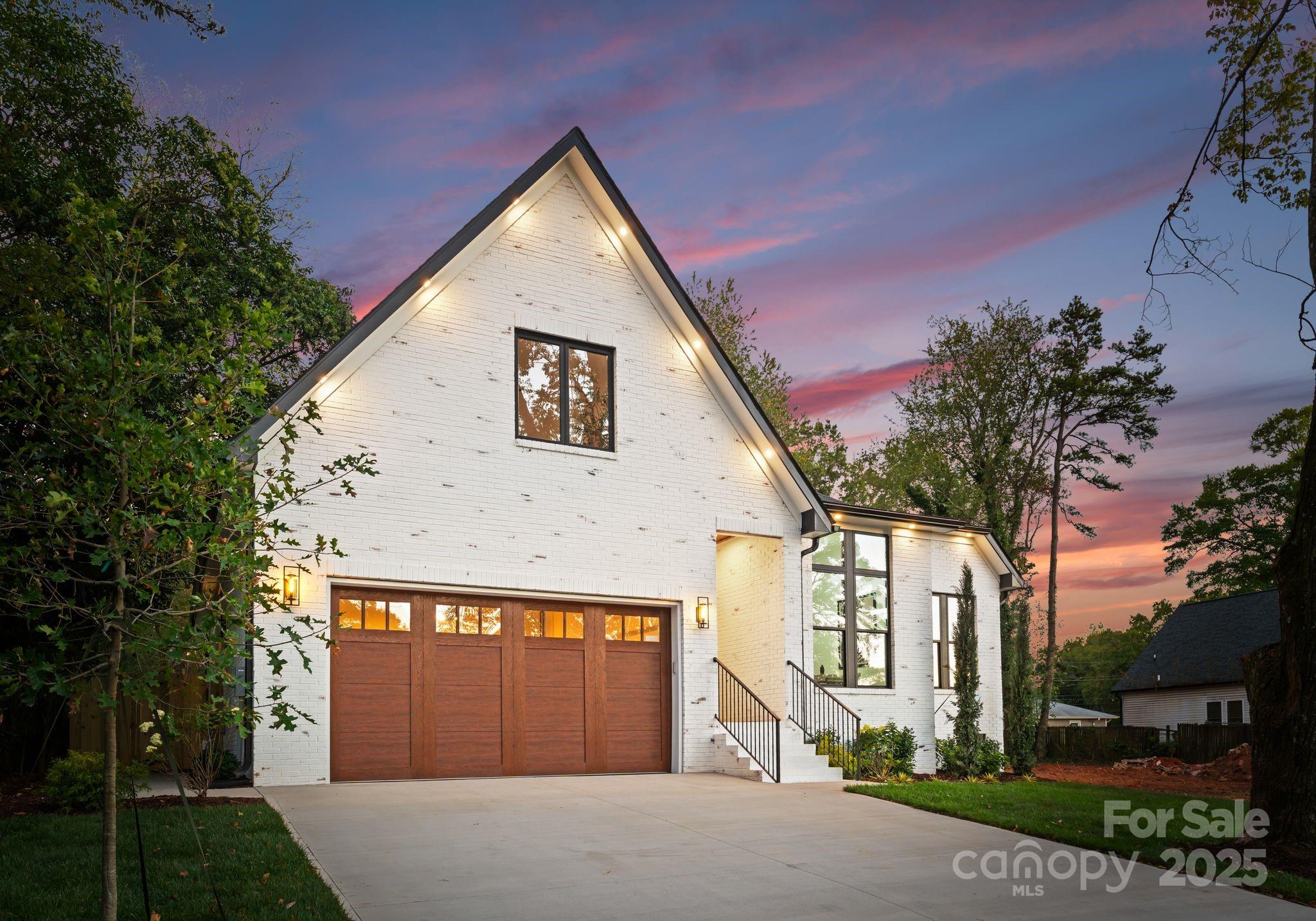 4641 Connecting Road Charlotte, NC 28209 - Photo 3 of 48 a front view of a house with a yard and garage
