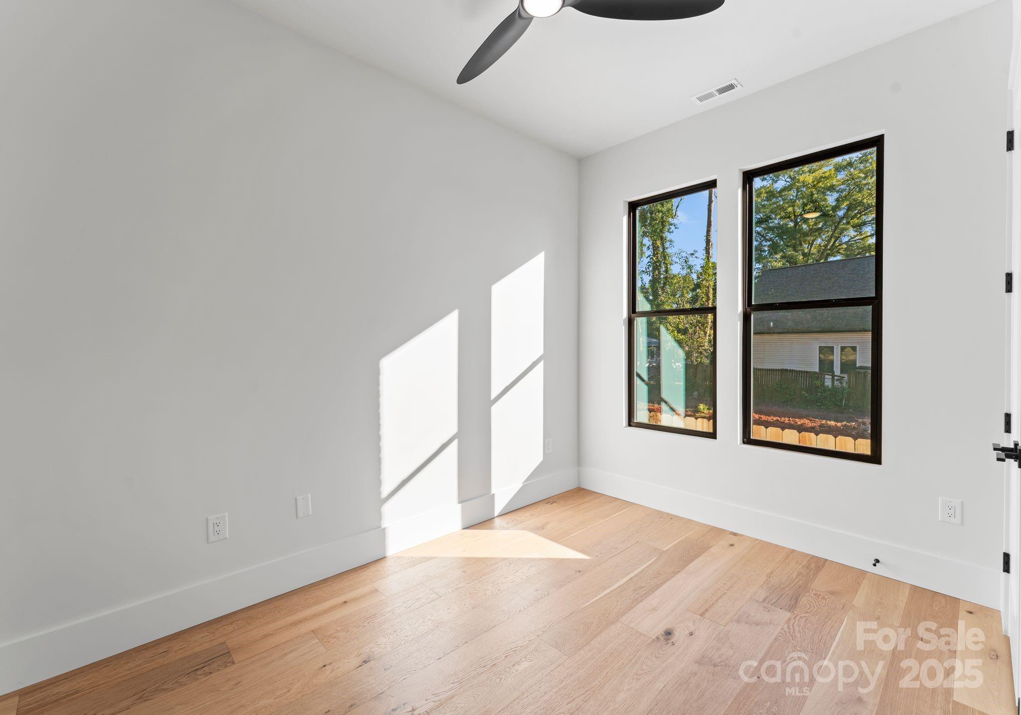 4641 Connecting Road Charlotte, NC 28209 - Photo 33 of 48 a view of an empty room with a window and wooden floor