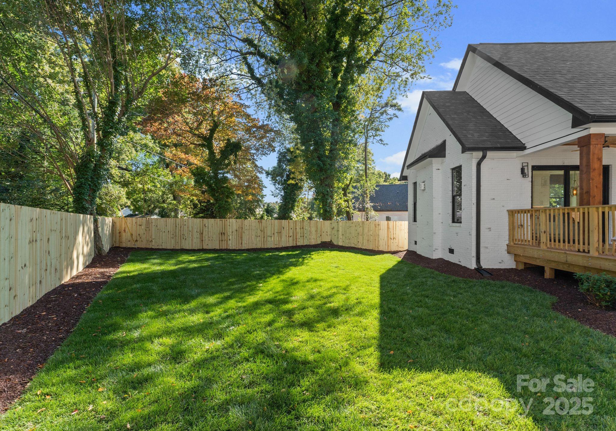 4641 Connecting Road Charlotte, NC 28209 - Photo 43 of 48 a backyard of a house with table and chairs