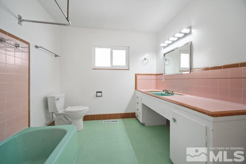 360 Sunset Drive Reno, NV 89509 - Photo 11 of 22 a bathroom with a sink and a mirror