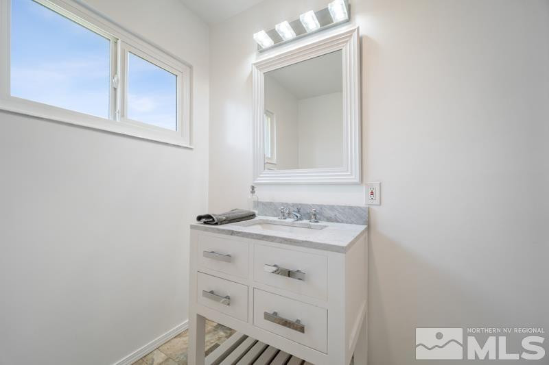 360 Sunset Drive Reno, NV 89509 - Photo 14 of 22 a bathroom with a sink and a mirror