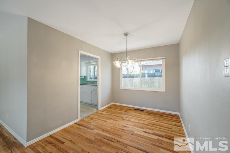 360 Sunset Drive Reno, NV 89509 - Photo 4 of 22 a view of an empty room with window and wooden floor
