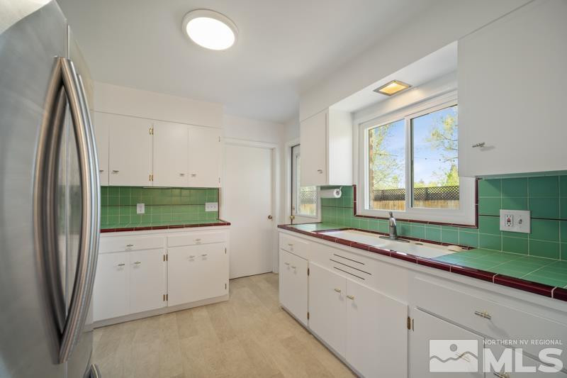360 Sunset Drive Reno, NV 89509 - Photo 5 of 22 a kitchen with stainless steel appliances granite countertop a sink and a refrigerator