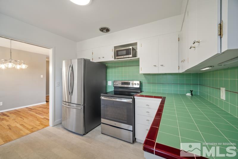 360 Sunset Drive Reno, NV 89509 - Photo 7 of 22 a kitchen with stainless steel appliances granite countertop a refrigerator and a sink