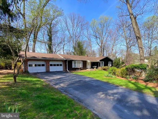 a view of house with outdoor space and garden
