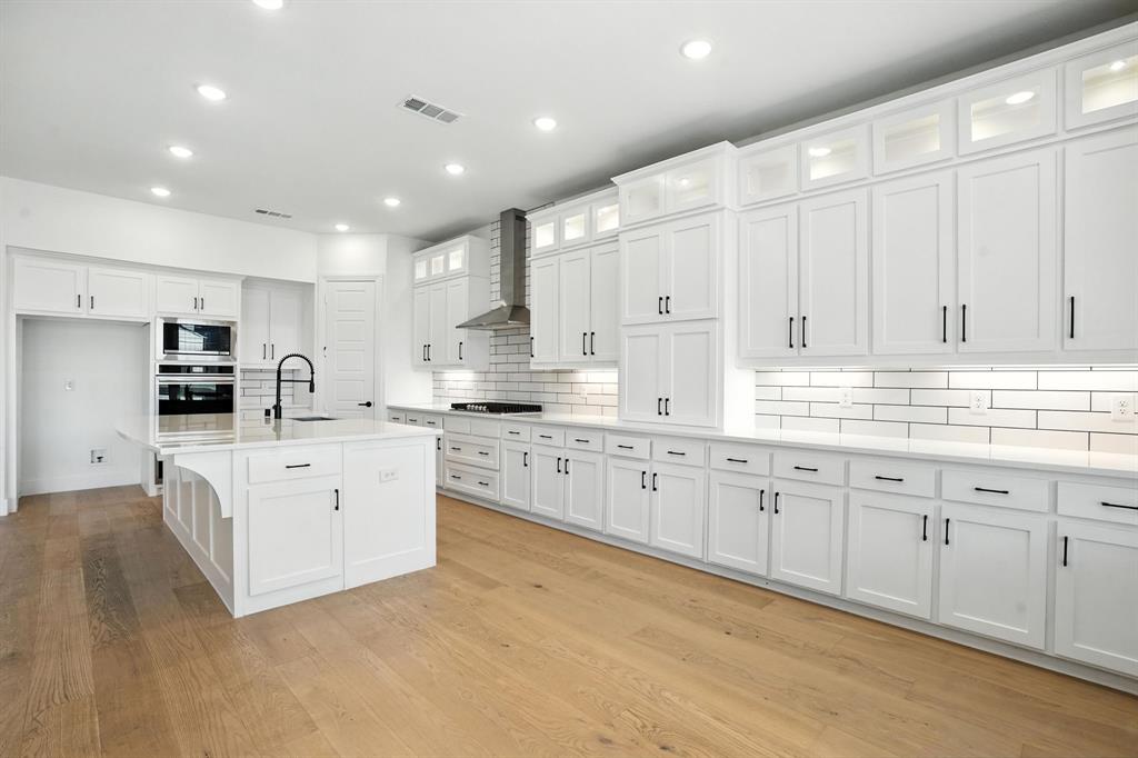 4621 Mount Vista Road Oak Point, TX 75068 - Photo 16 of 40 a kitchen with granite countertop white cabinets white stainless steel appliances with a sink and dishwasher