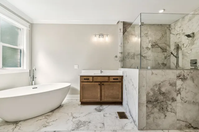 a spacious bathroom with a bathtub and shower