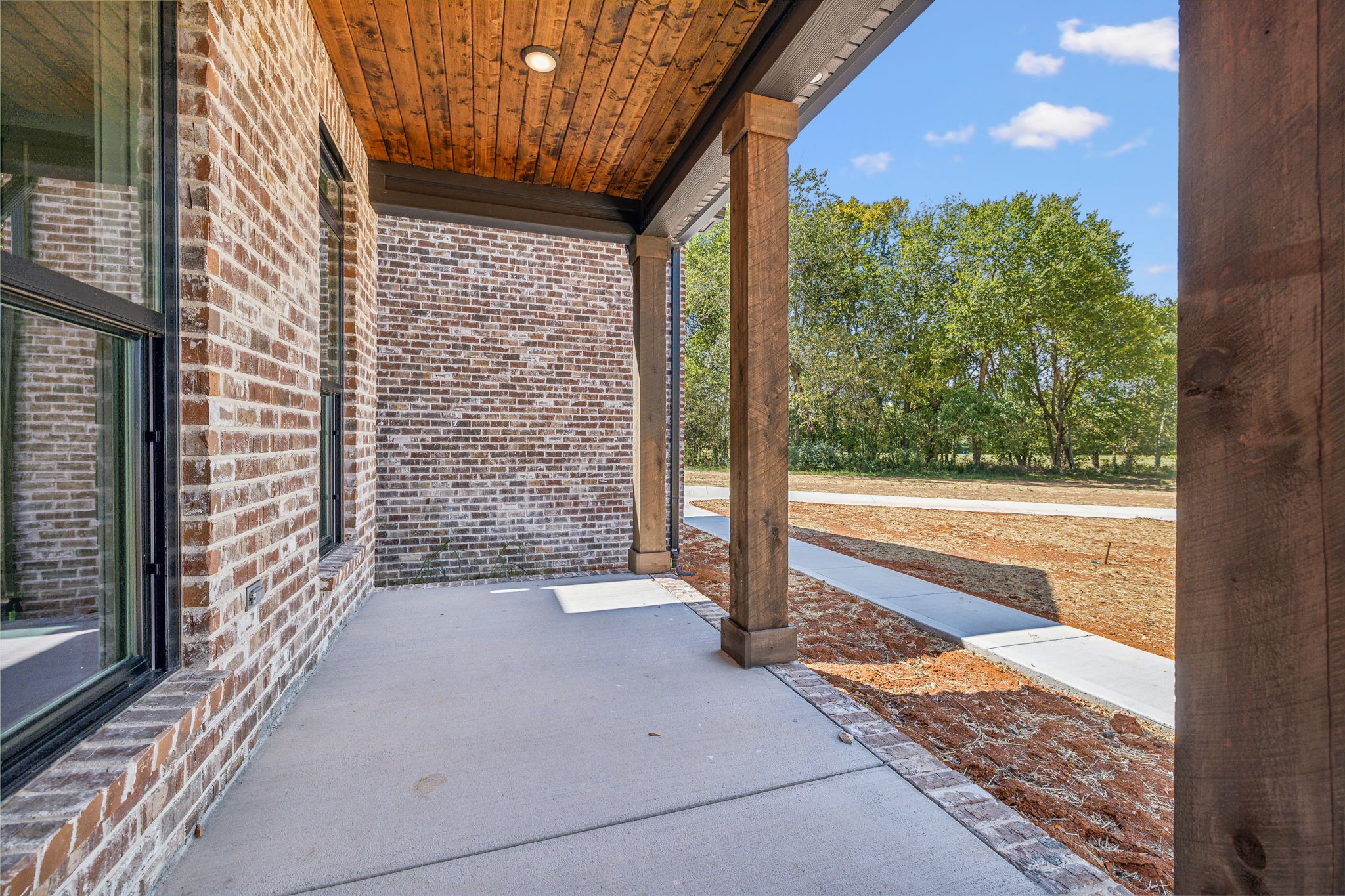 8625 Twelve Corners Road Lascassas, TN 37085 - Photo 2 of 25 a view of a porch with a floor to ceiling window next to a yard