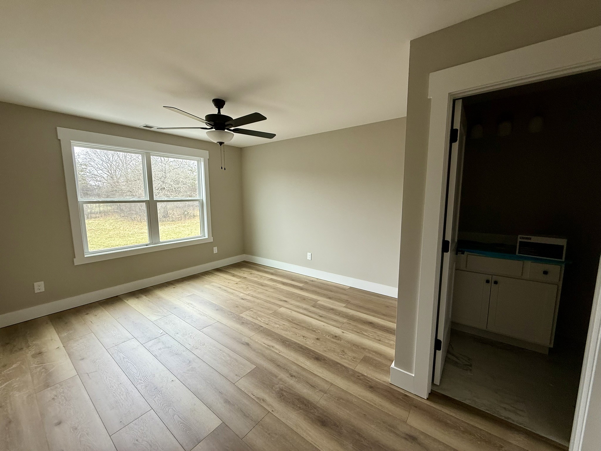8625 Twelve Corners Road Lascassas, TN 37085 - Photo 21 of 25 wooden floor in an empty room with a window