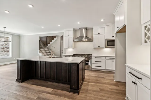 a kitchen with stainless steel appliances a stove top oven and refrigerator