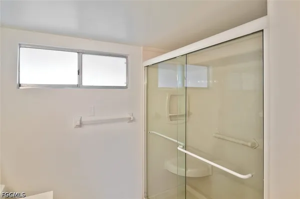 a kitchen with white cabinets a sink stove and refrigerator