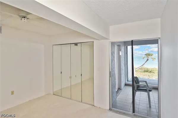 a kitchen with white cabinets and refrigerator