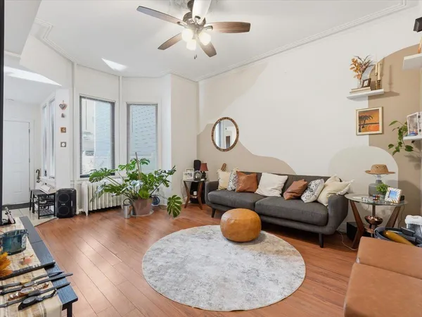 a living room with furniture and a wooden floor
