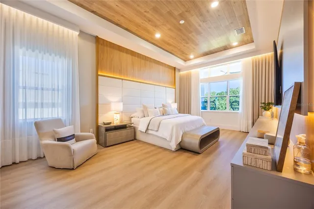 a spacious bedroom with a bed and glass window