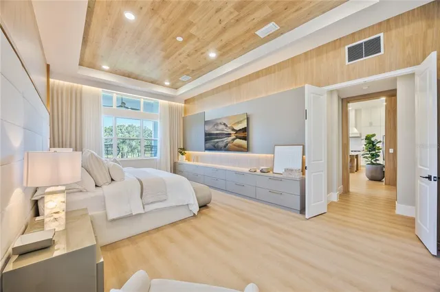 a spacious bedroom with a large bed and a large window