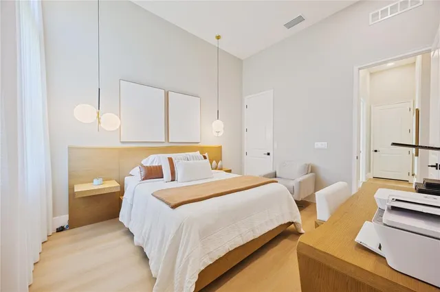 a bedroom with furniture and a lamp