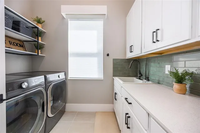 a kitchen with stainless steel appliances granite countertop a sink and a refrigerator