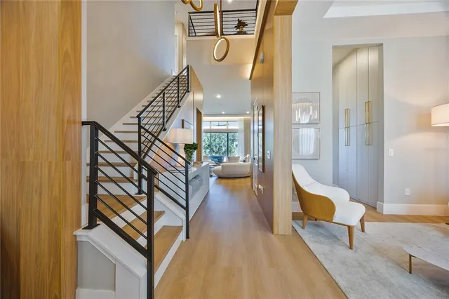 a view of entryway and hall with wooden floor