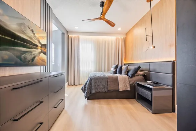 a bedroom with furniture and a flat screen tv