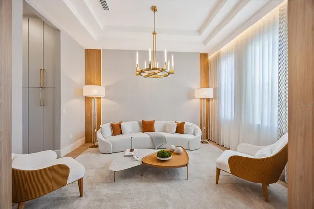 a living room with furniture and a chandelier