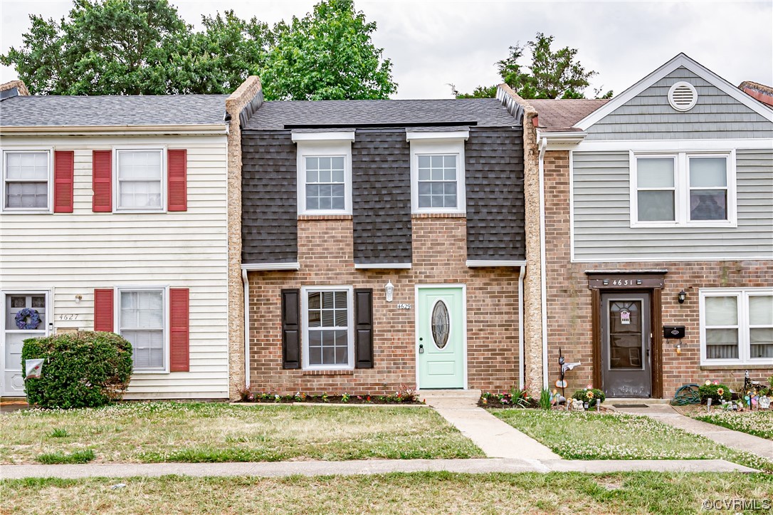 a front view of a house with a yard
