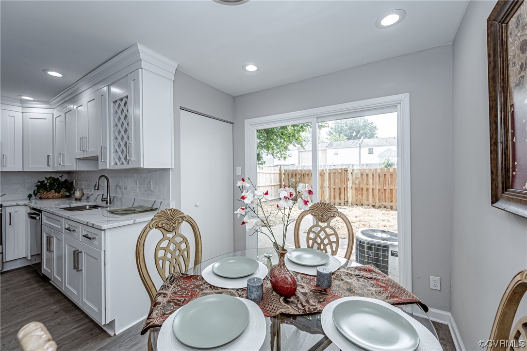4629 Coldstream Drive Richmond, VA 23234 - Photo 12 of 36 a very nice looking dining room with kitchen island furniture a rug a sink and a large window