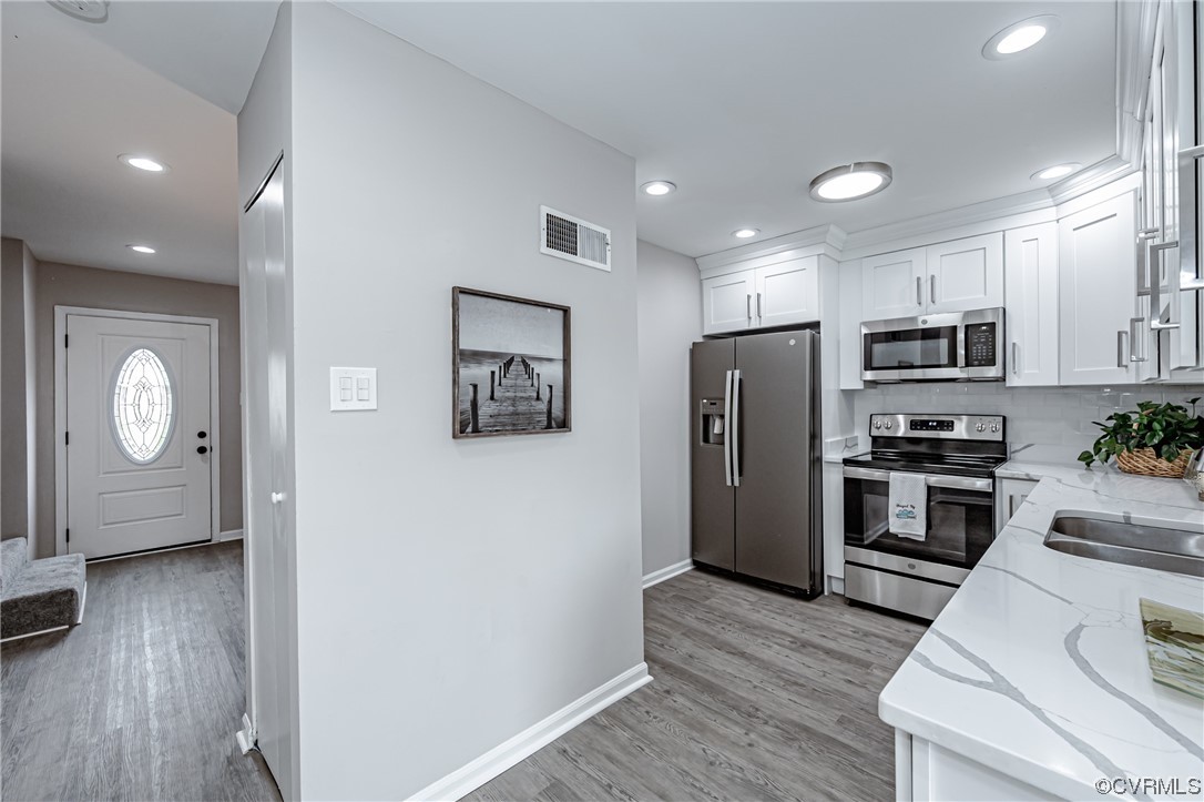4629 Coldstream Drive Richmond, VA 23234 - Photo 13 of 36 a kitchen with granite countertop a refrigerator a stove top oven a sink and wooden floor