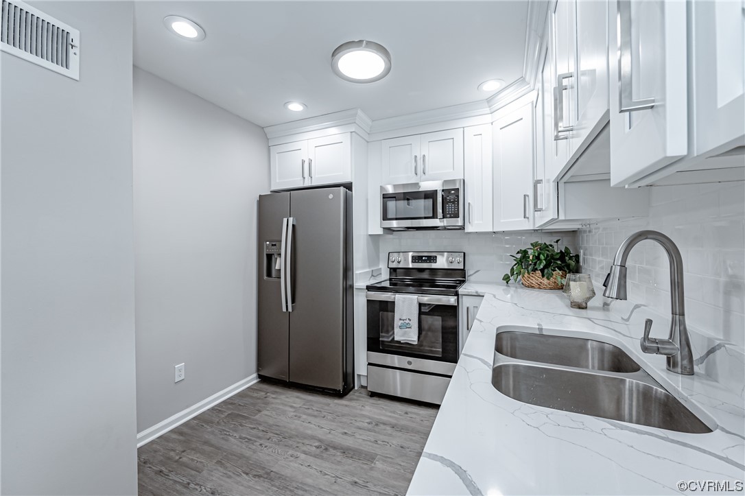 4629 Coldstream Drive Richmond, VA 23234 - Photo 18 of 36 a kitchen with stainless steel appliances a refrigerator sink and cabinets