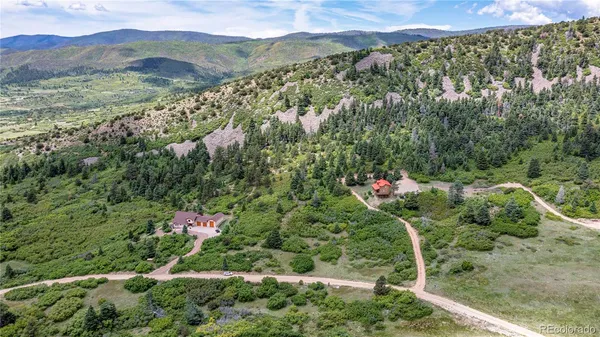 an aerial view of a house with a yard