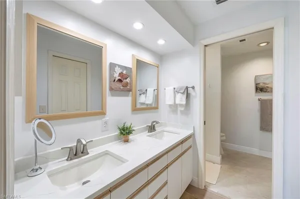 a bathroom with a sink double vanity and a mirror