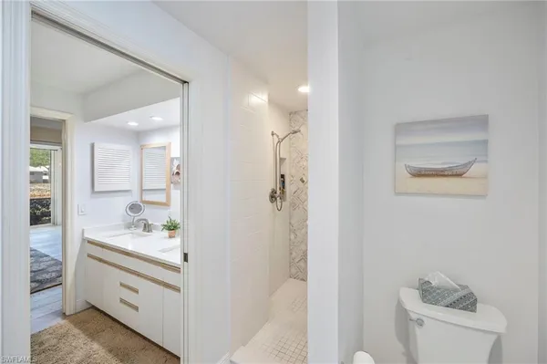 a bathroom with a sink a toilet and shower