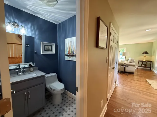 a en suite bathroom with a granite countertop sink and a mirror