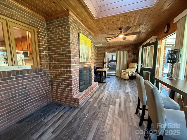 a view of a house with barbeque and wooden floor