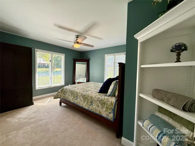 a bedroom with a large bed and a window