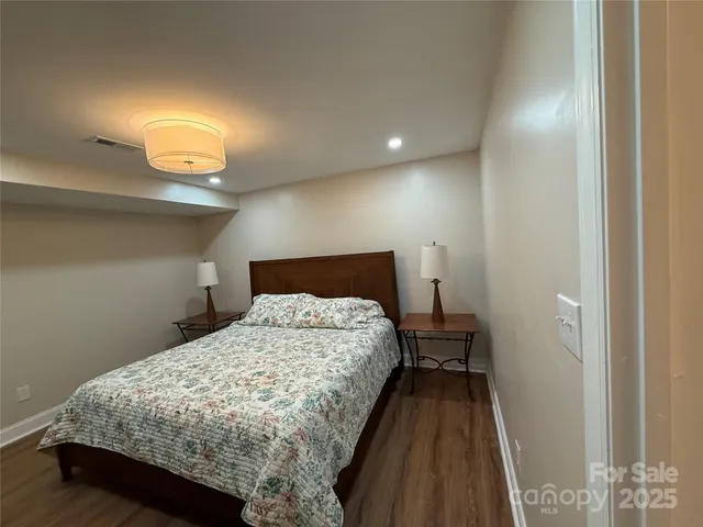 a bedroom with a bed and a night stand