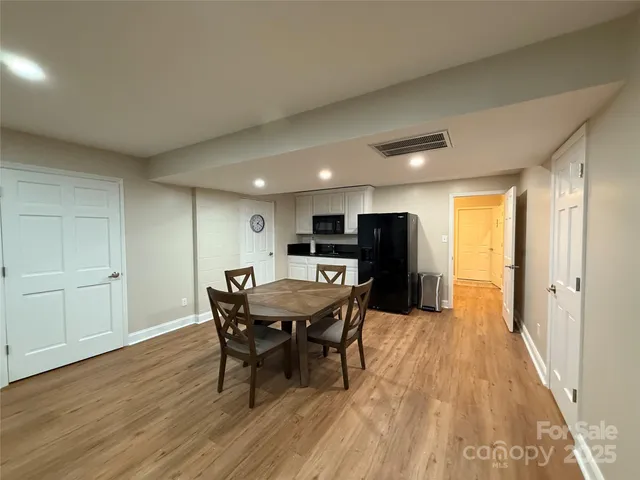 a dining room with furniture and wooden floor