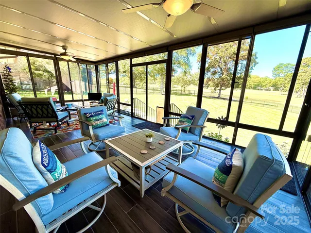 a living room with furniture and a floor to ceiling window